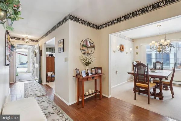 a dining room with furniture and wooden floor