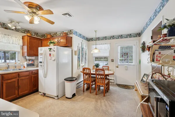 a dining room with furniture a chandelier and a flat screen tv