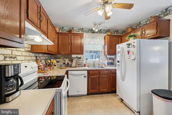 a kitchen with refrigerator and cabinets