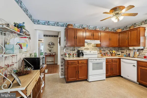 a kitchen with stainless steel appliances granite countertop a stove and cabinets