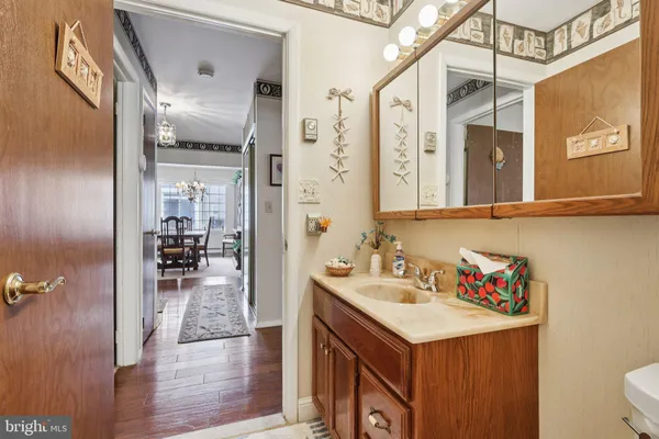 a bedroom with a bed a dresser next to a window