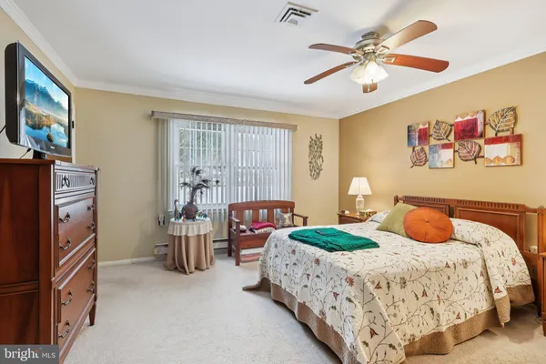 a bedroom with bed cabinets and window