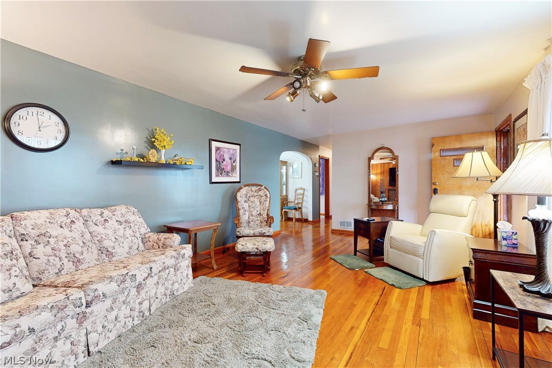 391 Canton Road Steubenville, OH 43953 - Photo 7 of 40 Living area featuring arched walkways, light wood finished floors, and ceiling fan