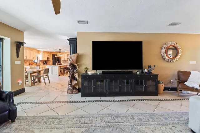 a kitchen with stainless steel appliances kitchen island granite countertop a refrigerator and a stove top oven