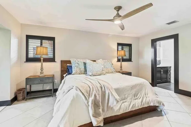 a bedroom with a bed and a painting on the wall