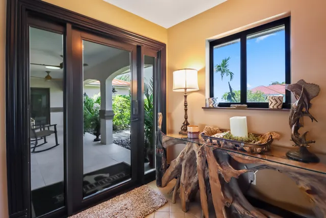 a living room with furniture and a large window with couch