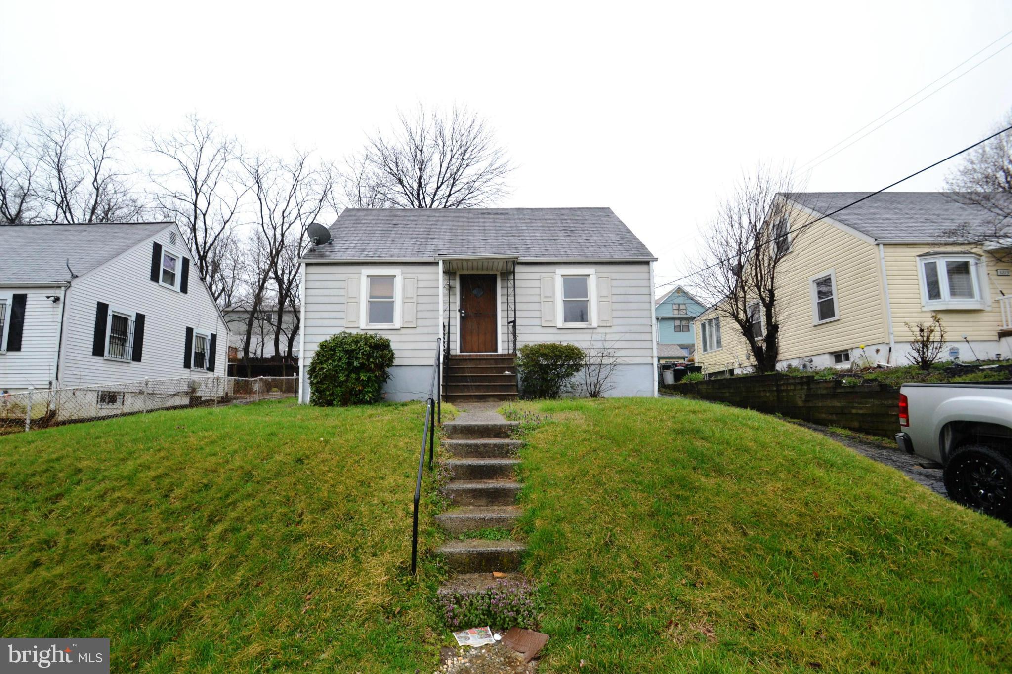 3211 Rosalie Road Baltimore, MD 21227 - Photo 2 of 25 a front view of a house with a yard and garage
