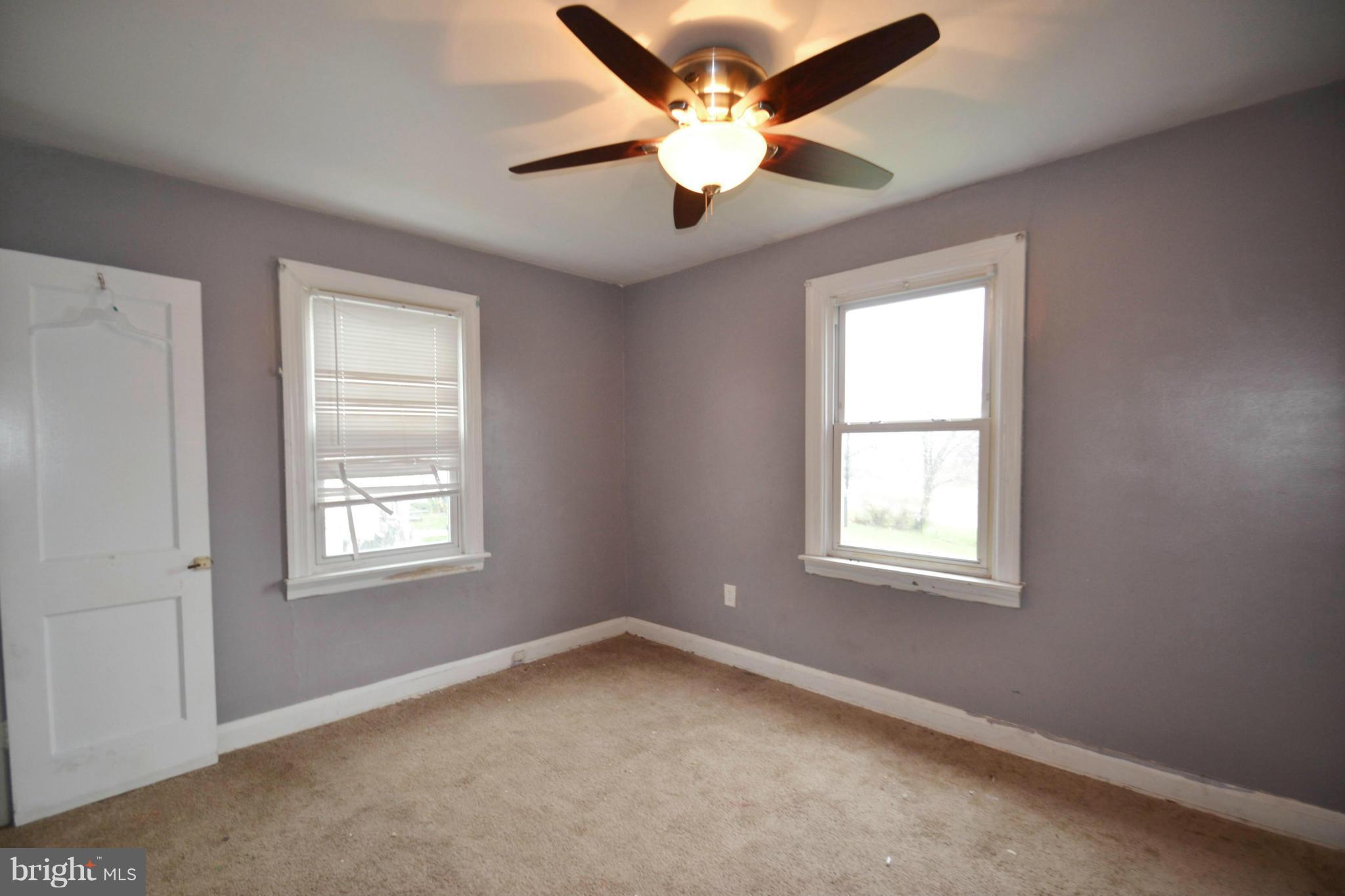 3211 Rosalie Road Baltimore, MD 21227 - Photo 12 of 25 an empty room with a window and a fan