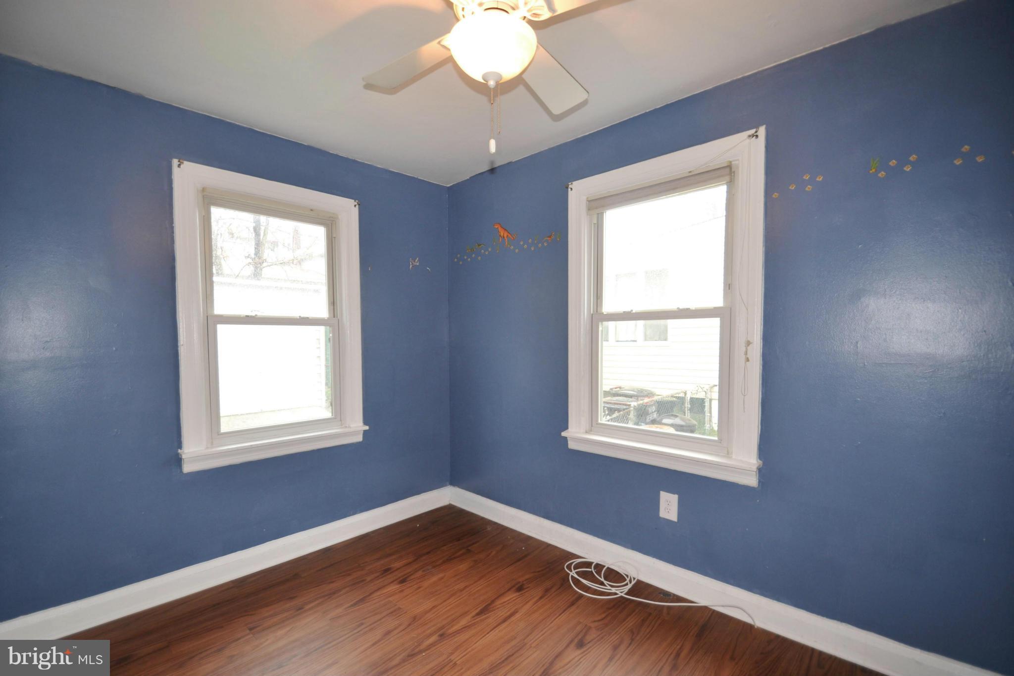 3211 Rosalie Road Baltimore, MD 21227 - Photo 15 of 25 a view of an empty room with wooden floor and a window