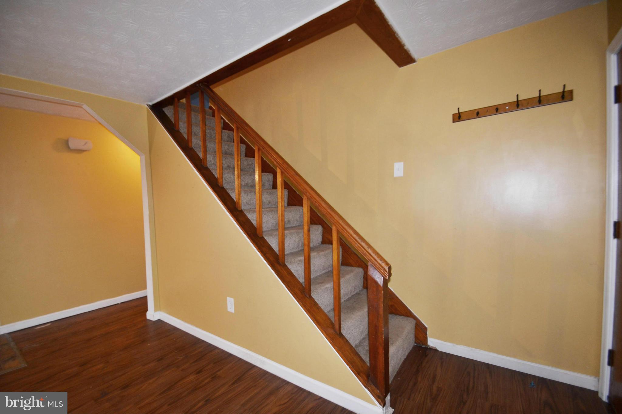 3211 Rosalie Road Baltimore, MD 21227 - Photo 17 of 25 a view of a hallway with wooden floor and staircase