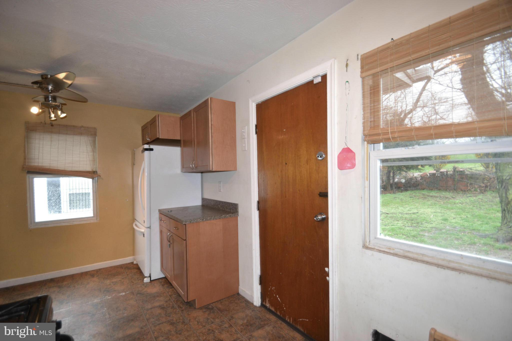 3211 Rosalie Road Baltimore, MD 21227 - Photo 8 of 25 wooden floor in an empty room with a window