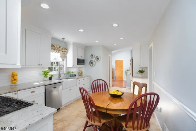 a living room with furniture flat screen tv and large windows