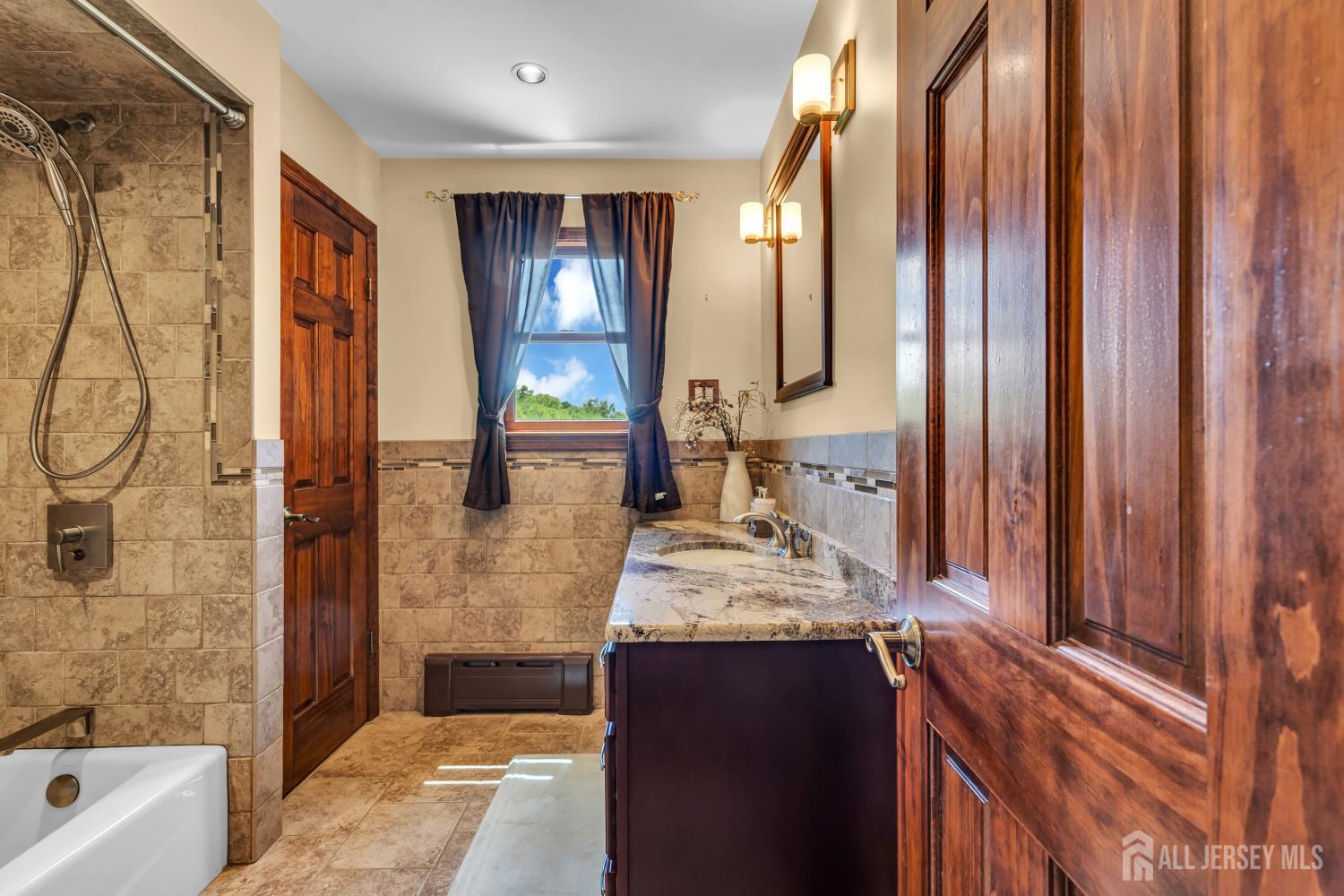 99 Schulmeister Road Old Bridge, NJ 08857 - Photo 16 of 49 a bathroom with a granite countertop sink and a mirror