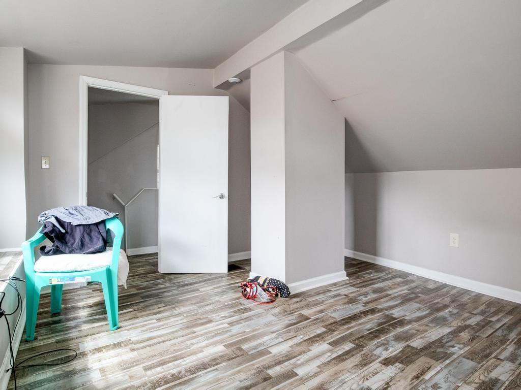 116 Riverview Avenue Aliquippa, PA 15001 - Photo 17 of 28 a bedroom with a bed and wooden floor