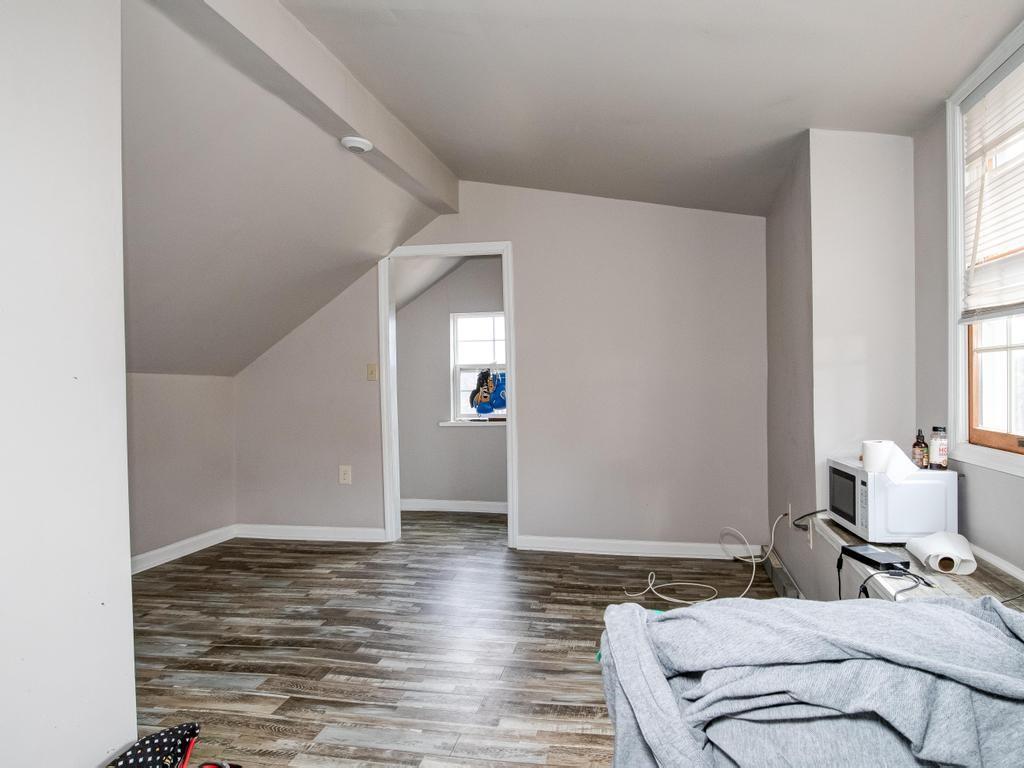 116 Riverview Avenue Aliquippa, PA 15001 - Photo 19 of 28 a bedroom with a bed and wooden floor