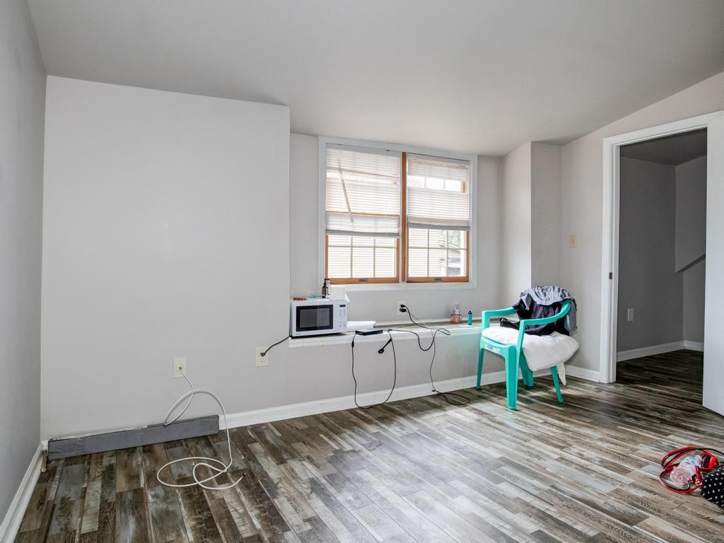 116 Riverview Avenue Aliquippa, PA 15001 - Photo 20 of 28 a spacious bedroom with a bed and wooden floor