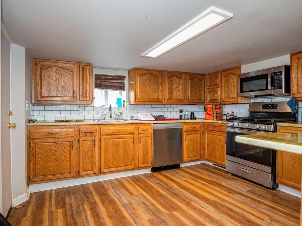 116 Riverview Avenue Aliquippa, PA 15001 - Photo 2 of 28 a kitchen with granite countertop a stove cabinets and microwave