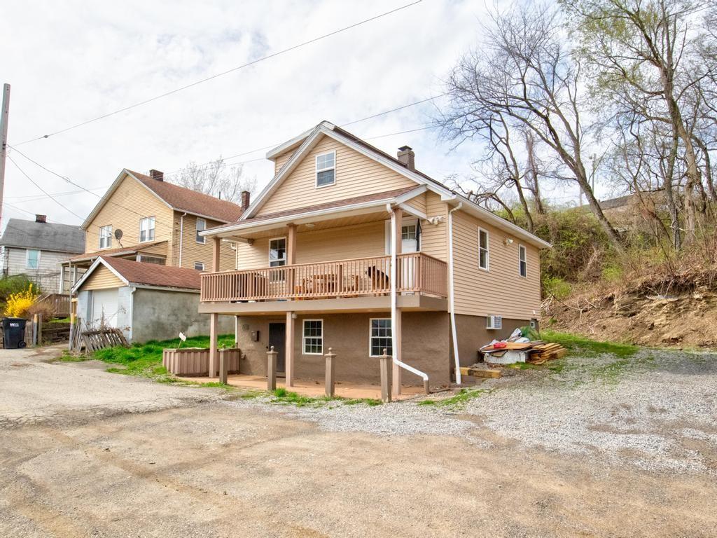 116 Riverview Avenue Aliquippa, PA 15001 - Photo 28 of 28 a view of a white house with a large space and a large tree