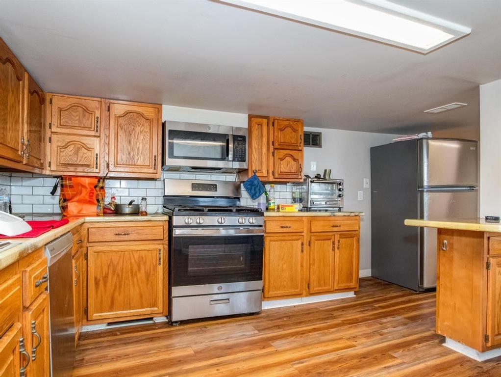 116 Riverview Avenue Aliquippa, PA 15001 - Photo 3 of 28 a kitchen with stainless steel appliances granite countertop a refrigerator and a stove top oven