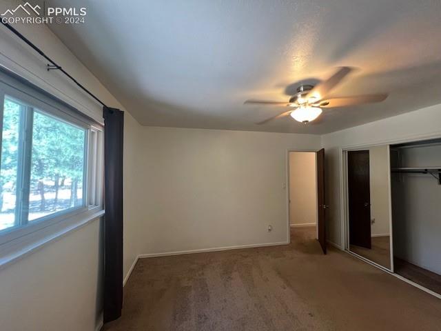 7280 Mathews Road Colorado Springs, CO 80908 - Photo 17 of 31 Unfurnished bedroom with ceiling fan, carpet flooring, and a closet