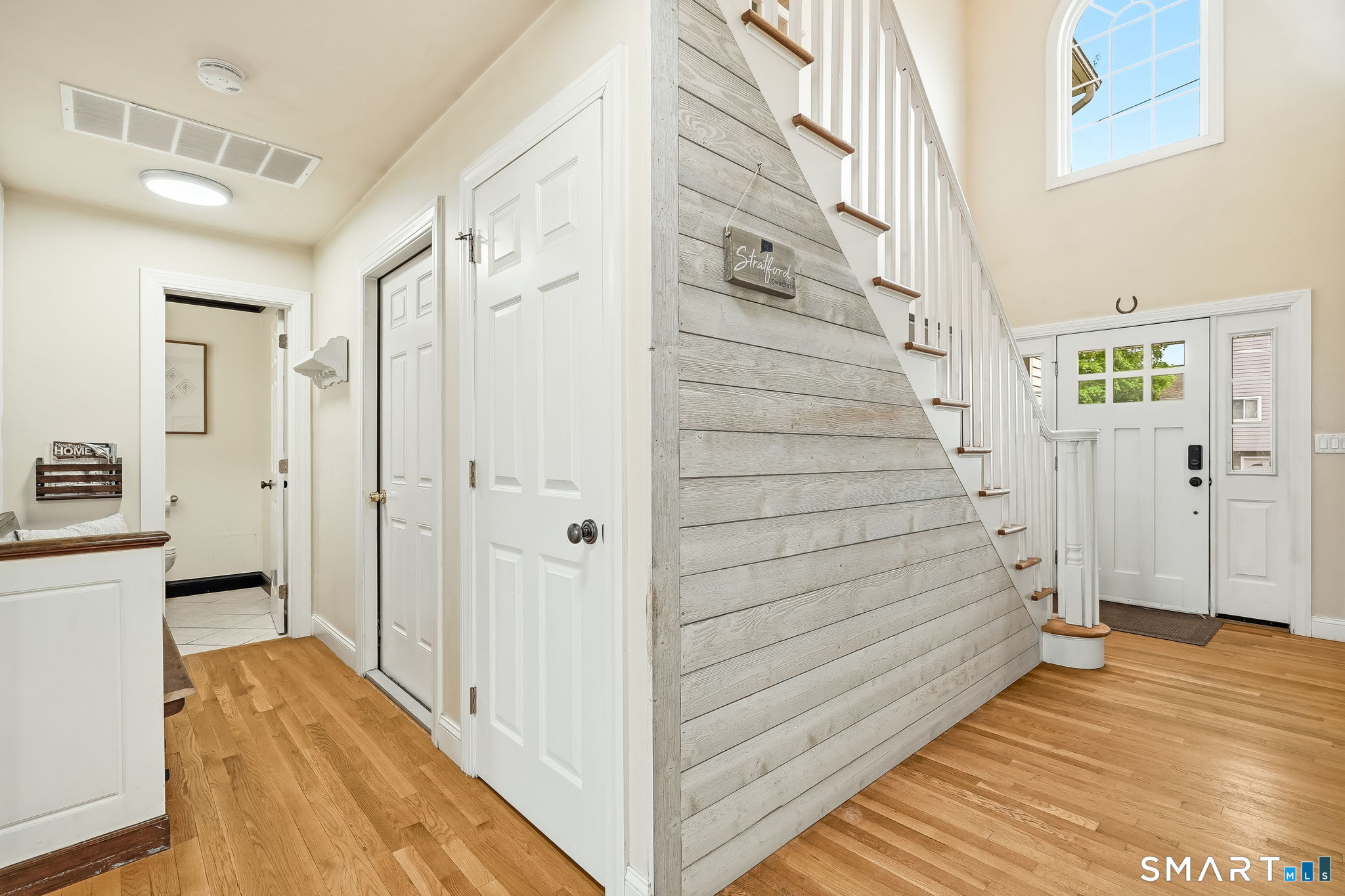 80 3rd Avenue Stratford, CT 06615 - Photo 19 of 40 a view of a hallway with wooden floor and staircase