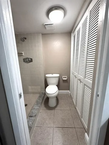 a bathroom with a toilet and a shower