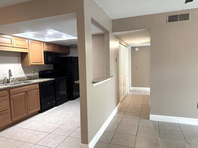 a kitchen with a refrigerator and a sink