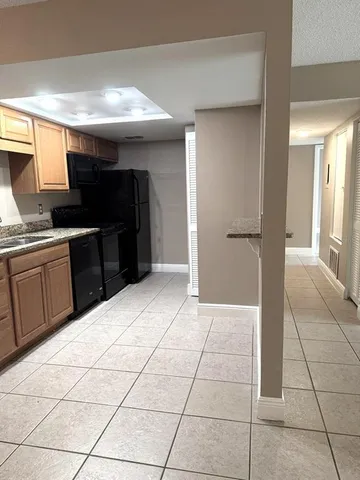 a kitchen with stainless steel appliances a sink and cabinets
