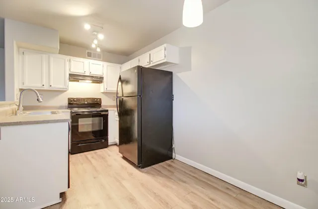 a kitchen with a refrigerator stove and sink