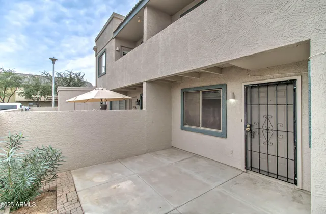 a roof deck with table and chairs