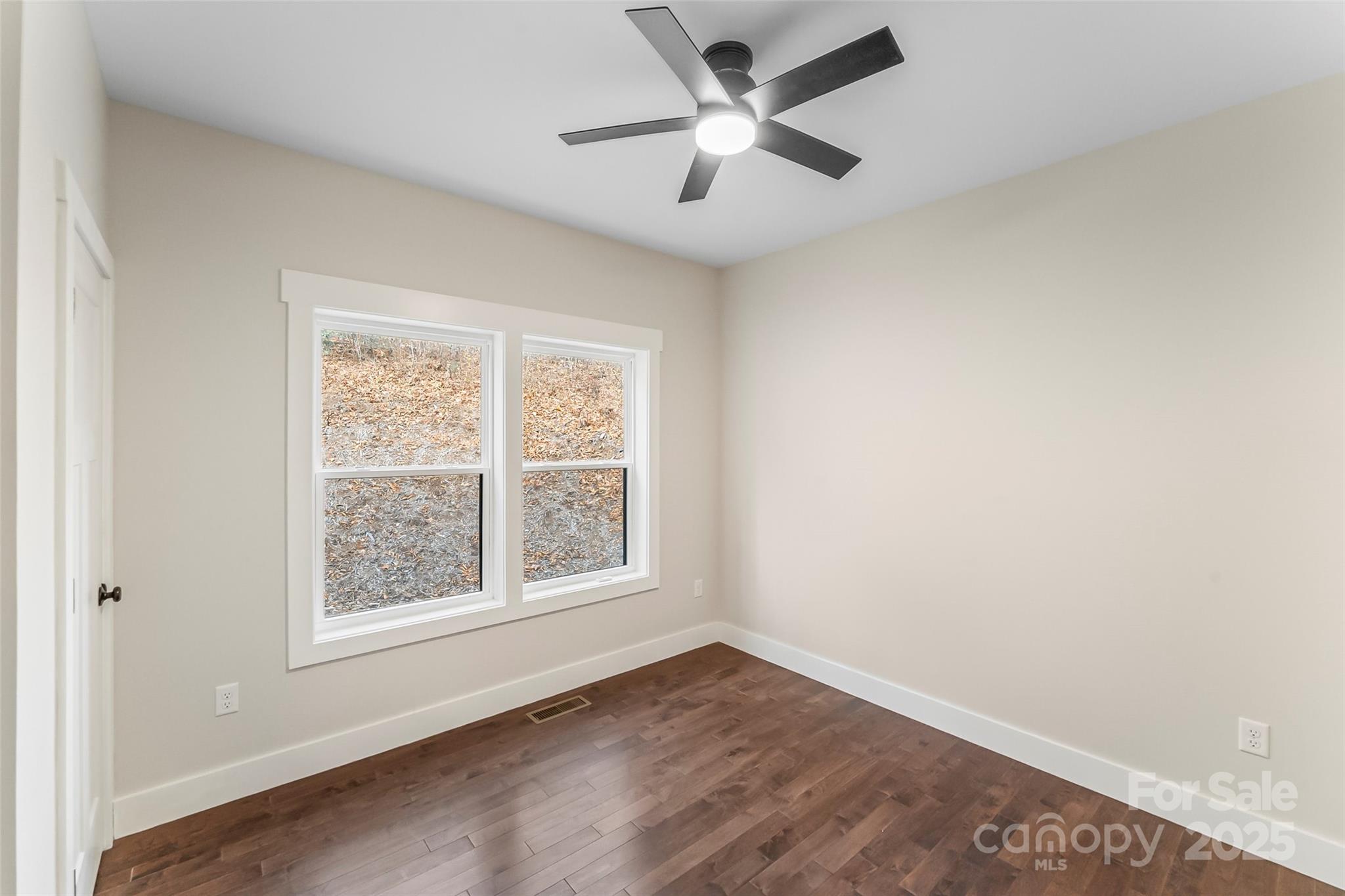 457 Blue Ridge Drive North Marion, NC 28752 - Photo 14 of 34 an empty room with a window and a fan
