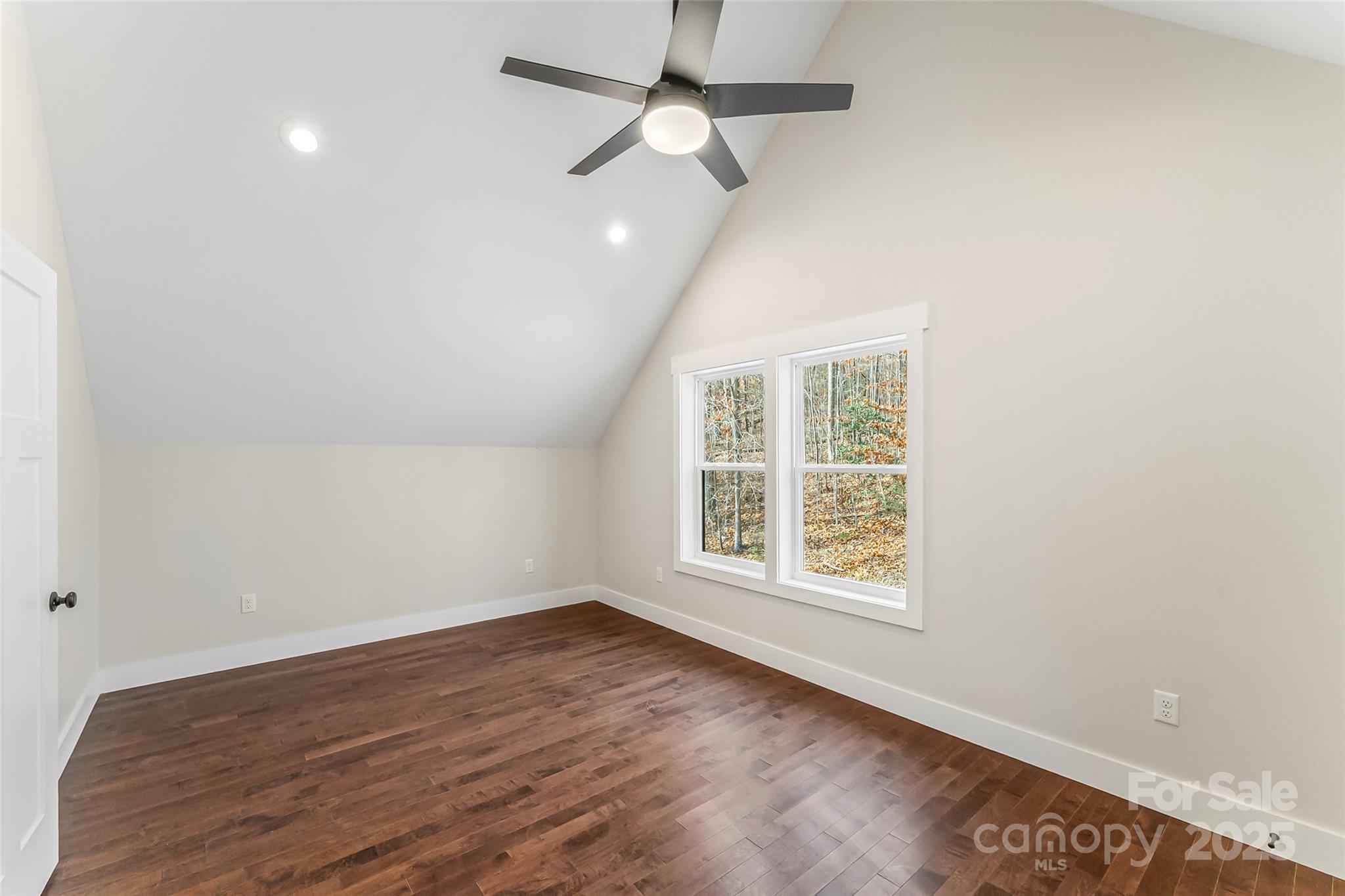 457 Blue Ridge Drive North Marion, NC 28752 - Photo 17 of 34 an empty room with wooden floor ceiling fan and windows