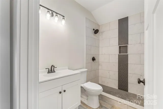 a bathroom with a toilet a sink and shower