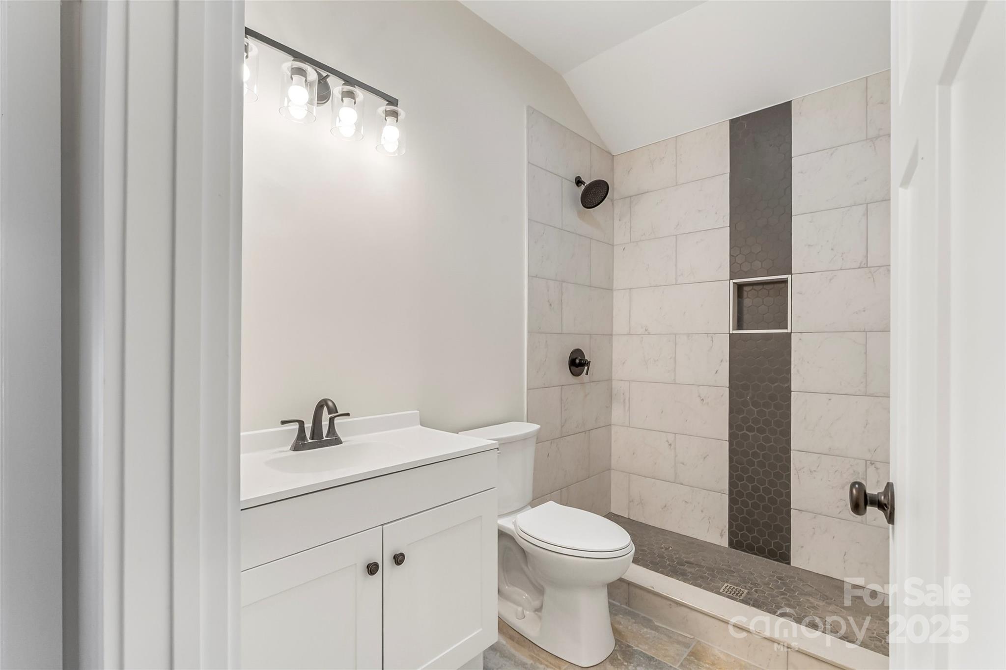 457 Blue Ridge Drive North Marion, NC 28752 - Photo 18 of 34 a bathroom with a toilet a sink and shower