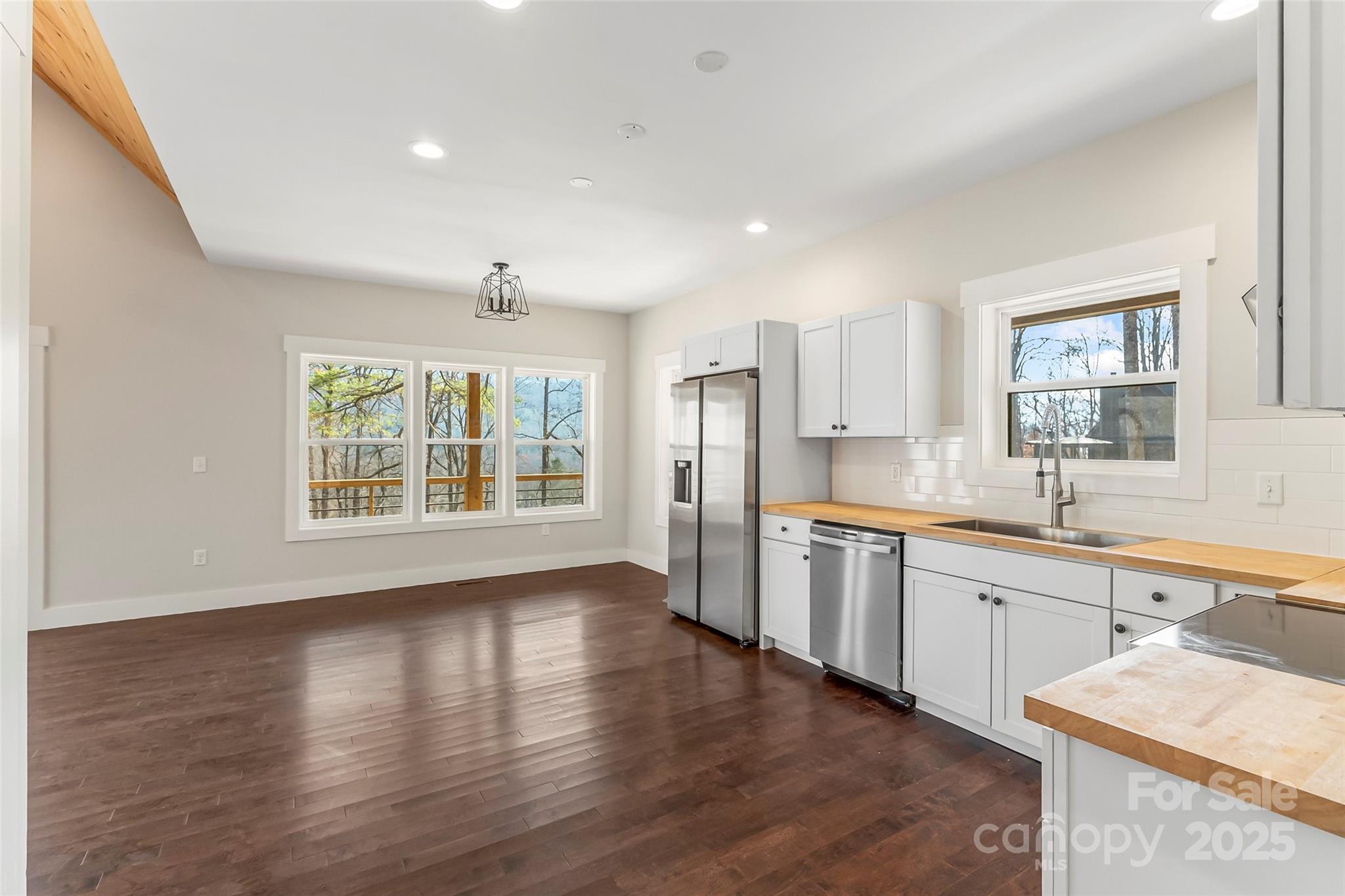 457 Blue Ridge Drive North Marion, NC 28752 - Photo 6 of 34 a large kitchen with stainless steel appliances granite countertop a sink and wooden floor
