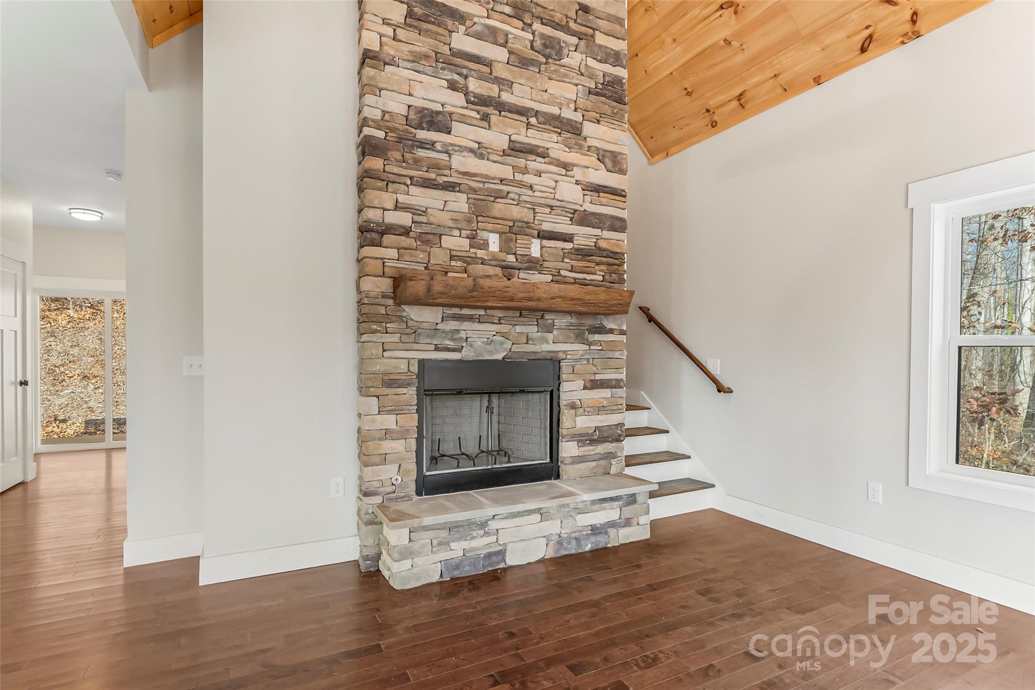 457 Blue Ridge Drive North Marion, NC 28752 - Photo 10 of 34 an empty room with wooden floor windows and staircase