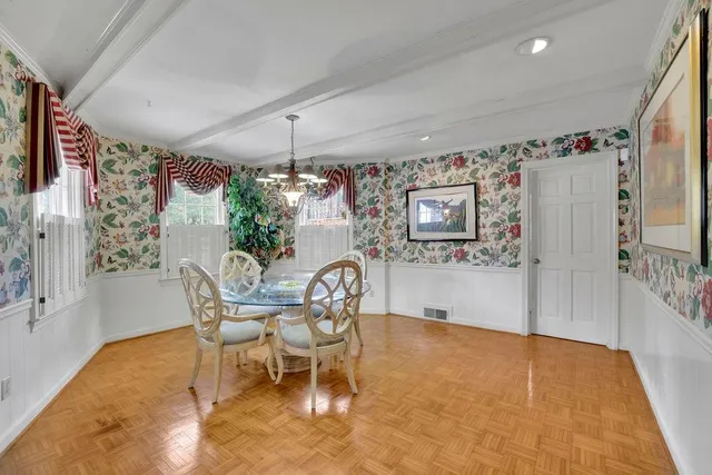 a view of a dining room with furniture and chandelier