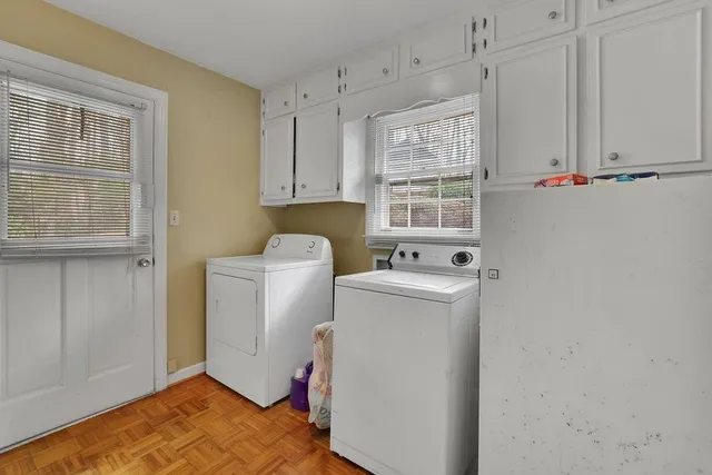 a bathroom with a granite countertop sink mirror vanity and toilet