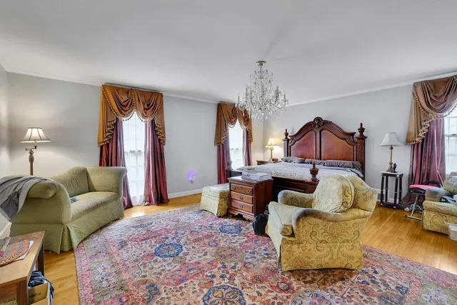 a living room with furniture and a chandelier