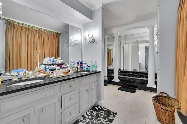 a view of a dining room with furniture chandelier and window