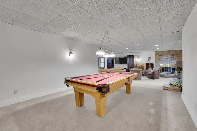 a dining room with furniture and a chandelier
