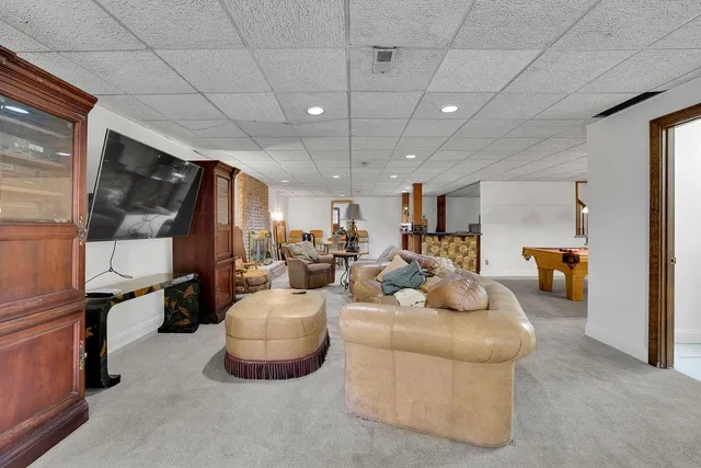 a bedroom with furniture and a large window