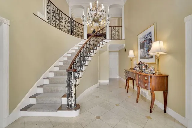 a living room with furniture a lamp and a window