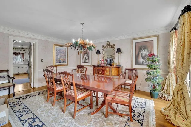 a view of a dining room with furniture and a chandelier