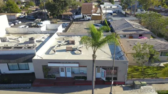 a view of a car park in front of shop