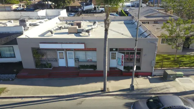 an aerial view of a residential apartment building with a yard