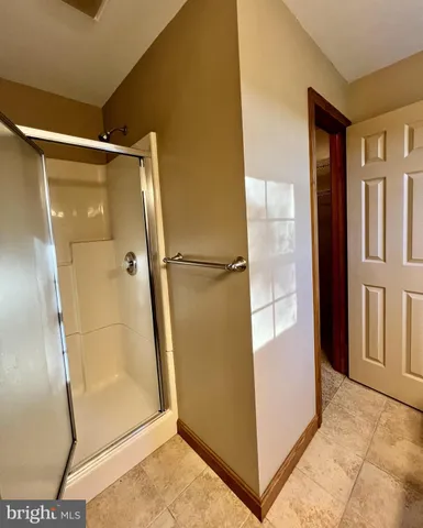 a bathroom with a glass shower door