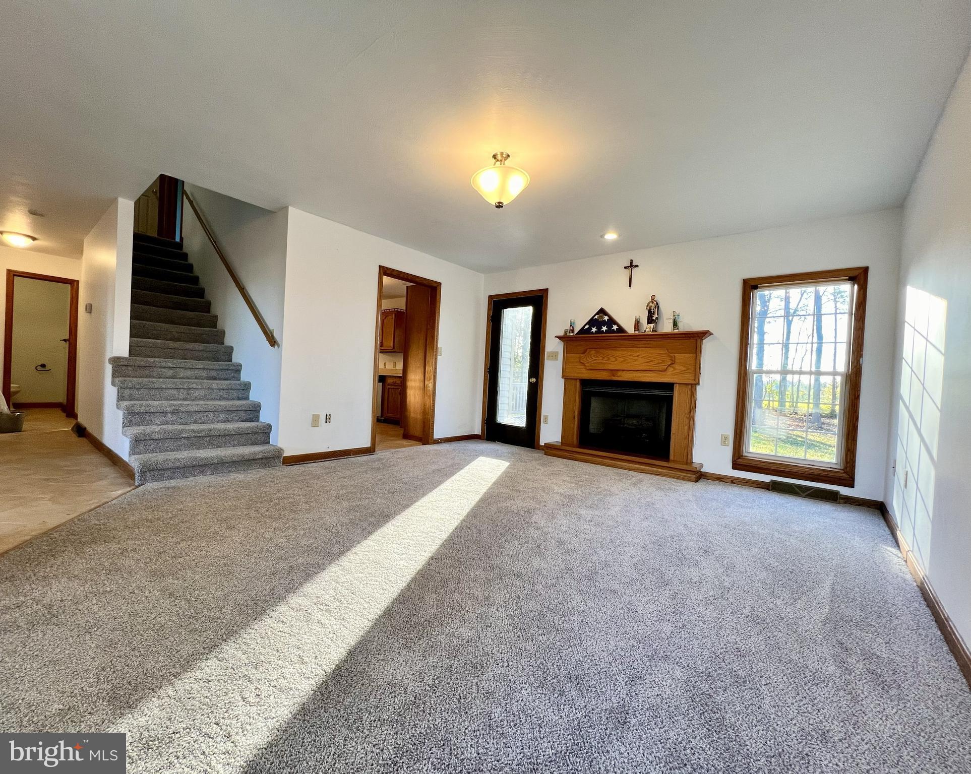 179 Sylvan Heights Road Du Bois, PA 15801 - Photo 6 of 40 an empty room with fireplace and windows