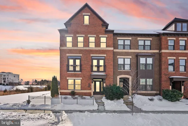 a front view of a residential apartment building with a yard