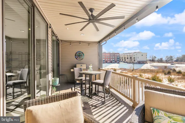 a spacious bedroom with a large bed a flat screen tv and a large window with the outer view